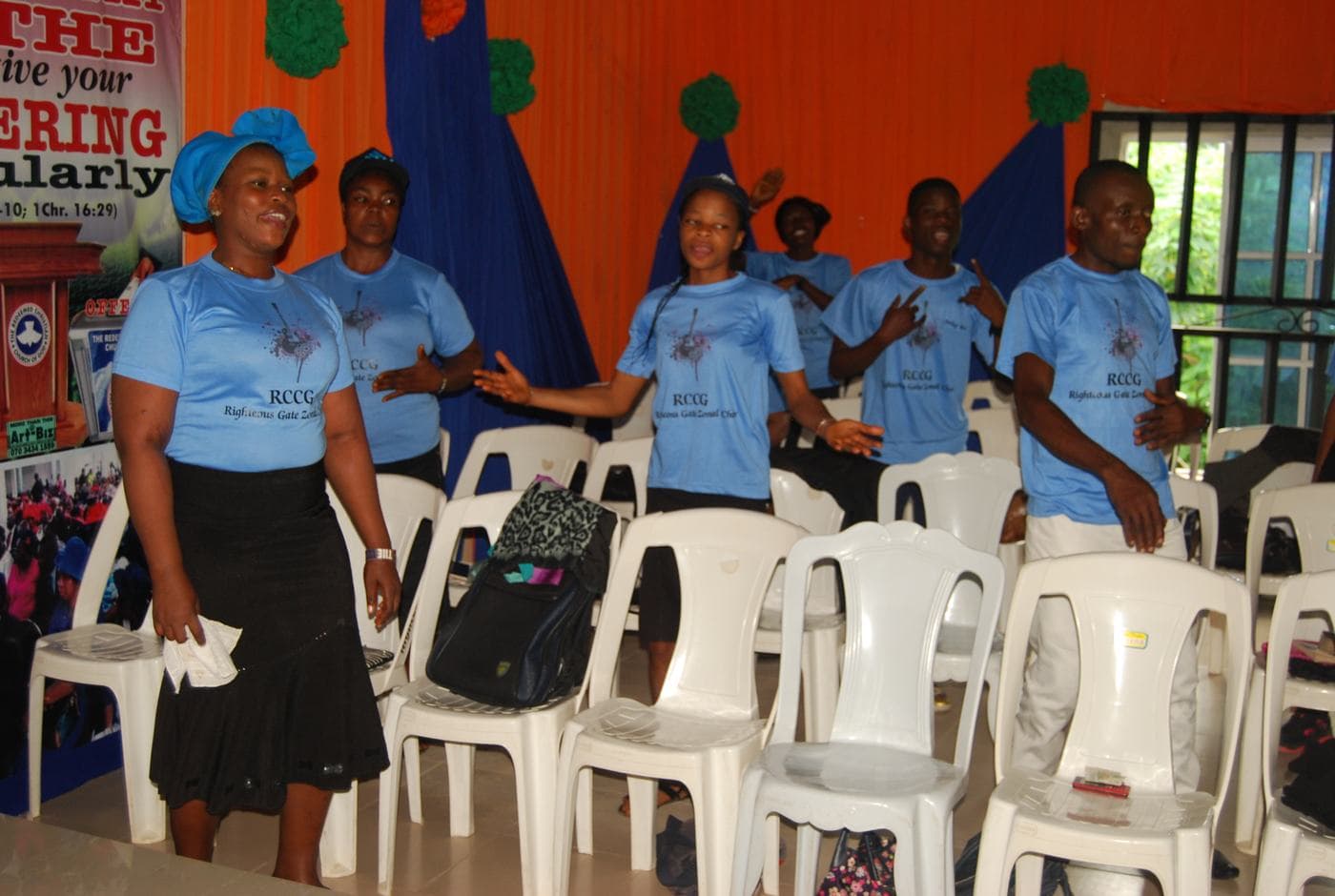The choir gathered on stage in matching sky-blue shirts.