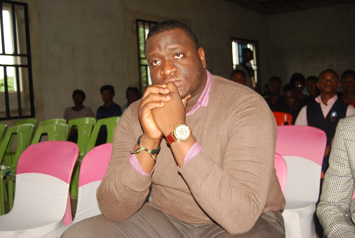 A member of the congregation seated, listening.
