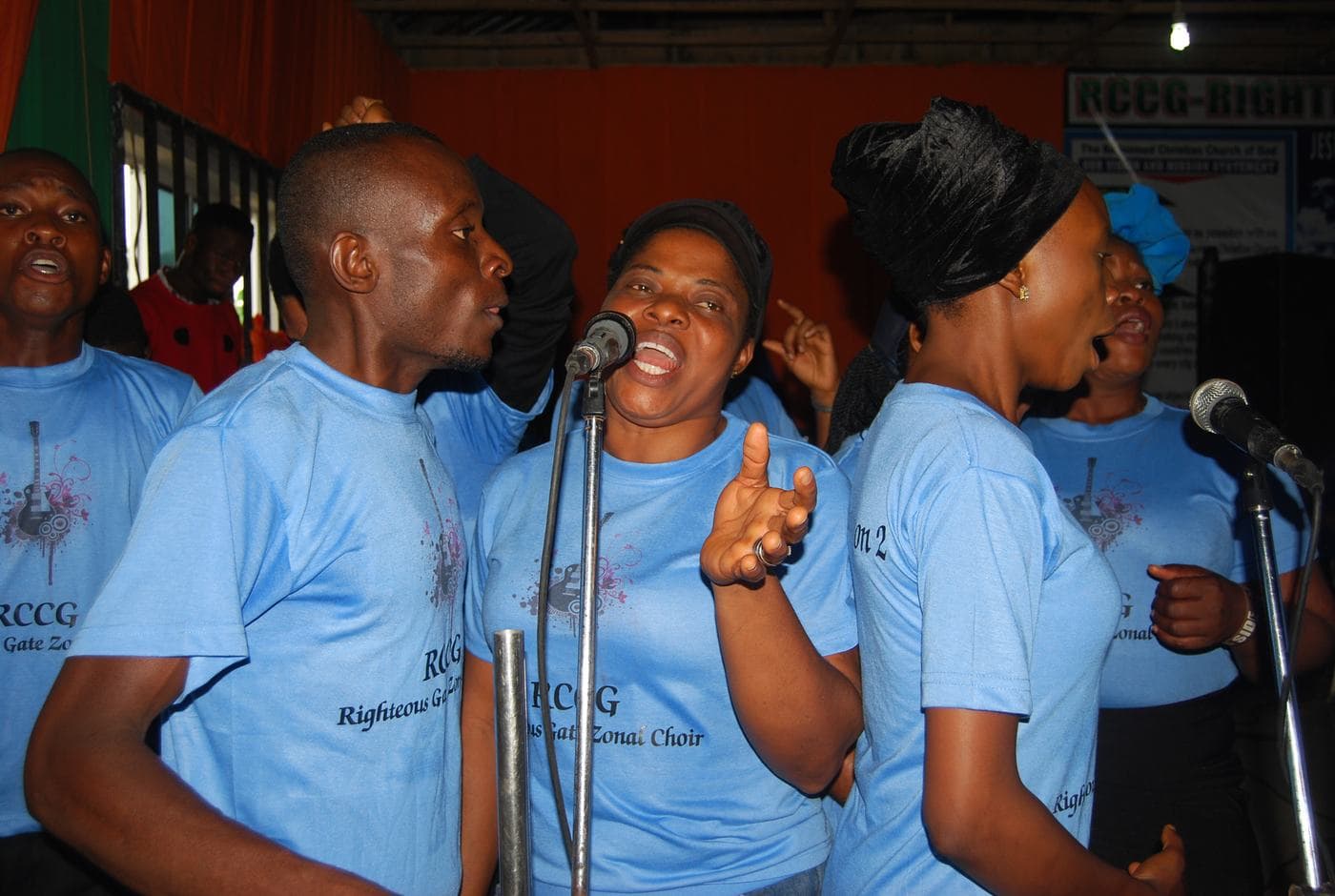The choir gathered on stage in matching sky-blue shirts.