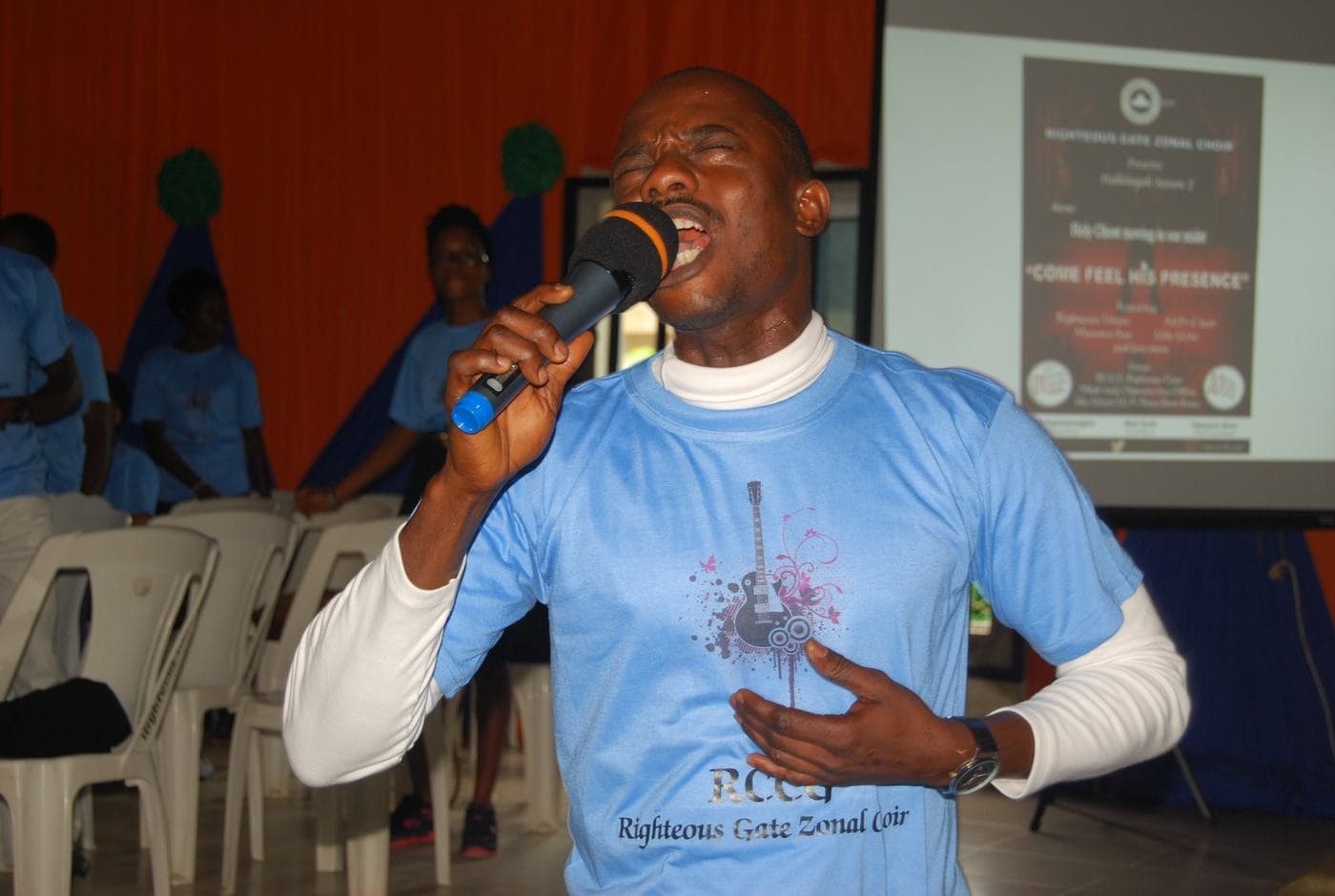 Members of the choir singing together indoors.