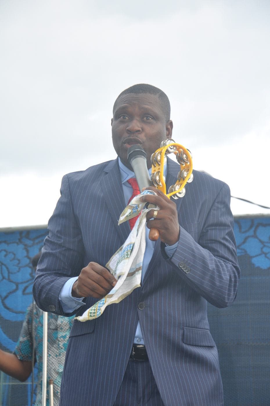 A minister addressing the crowd outdoors.