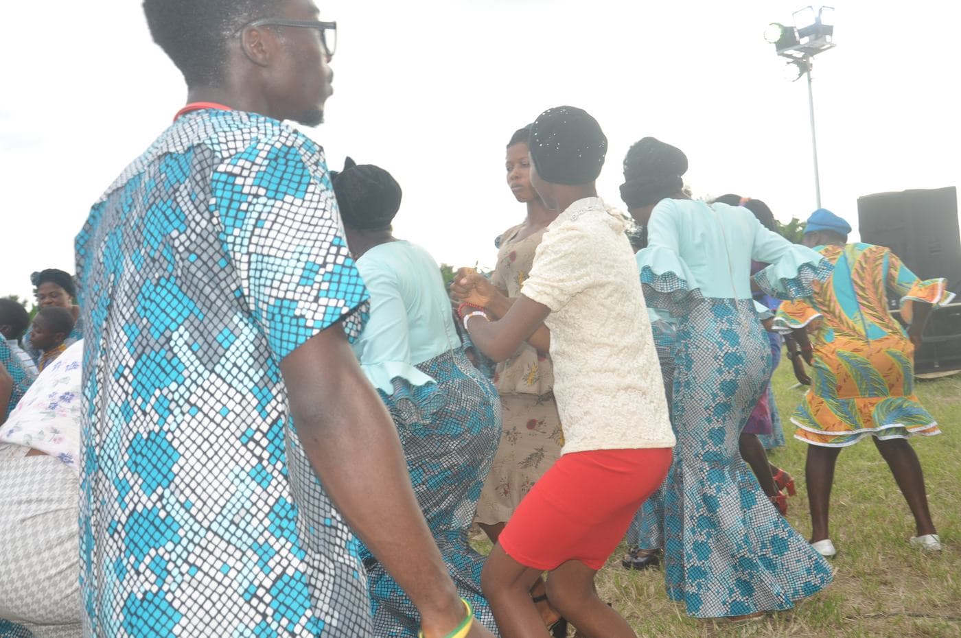 Members of the congregation worshipping in daylight.