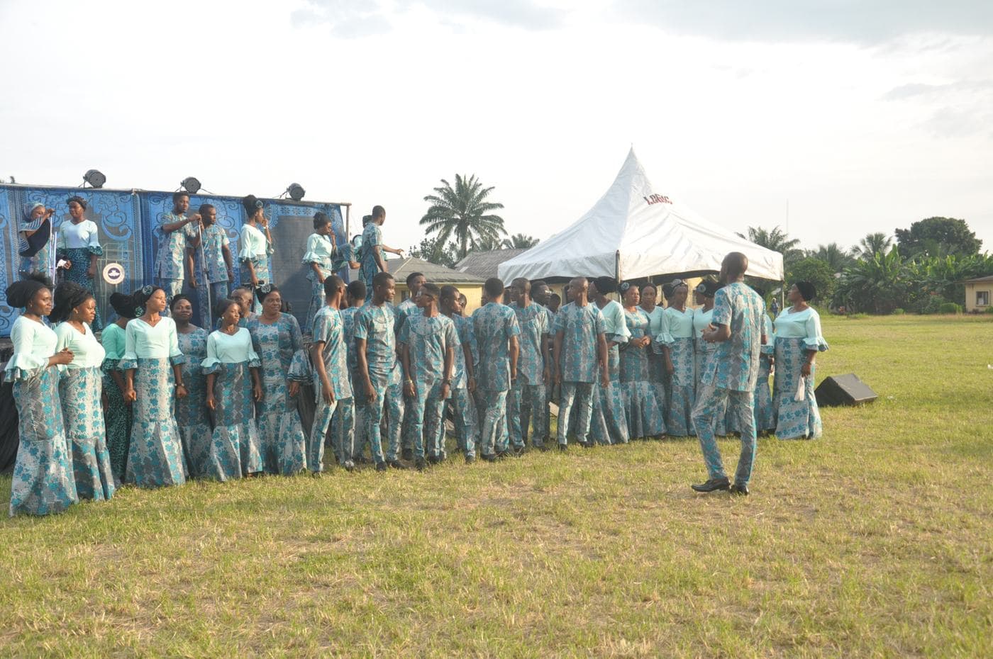 Members of the congregation worshipping in daylight.