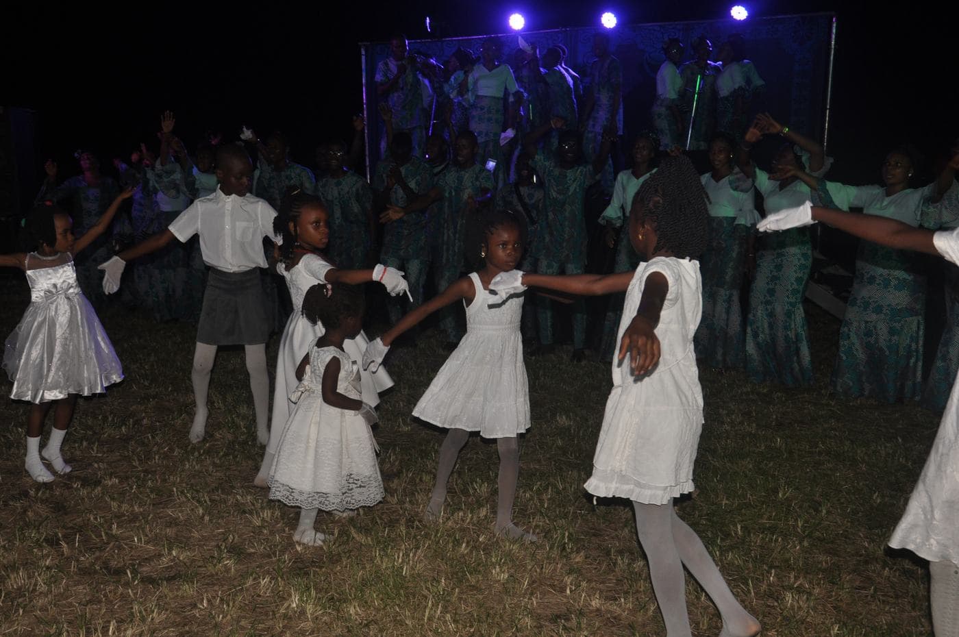 Members of the congregation worshipping in daylight.
