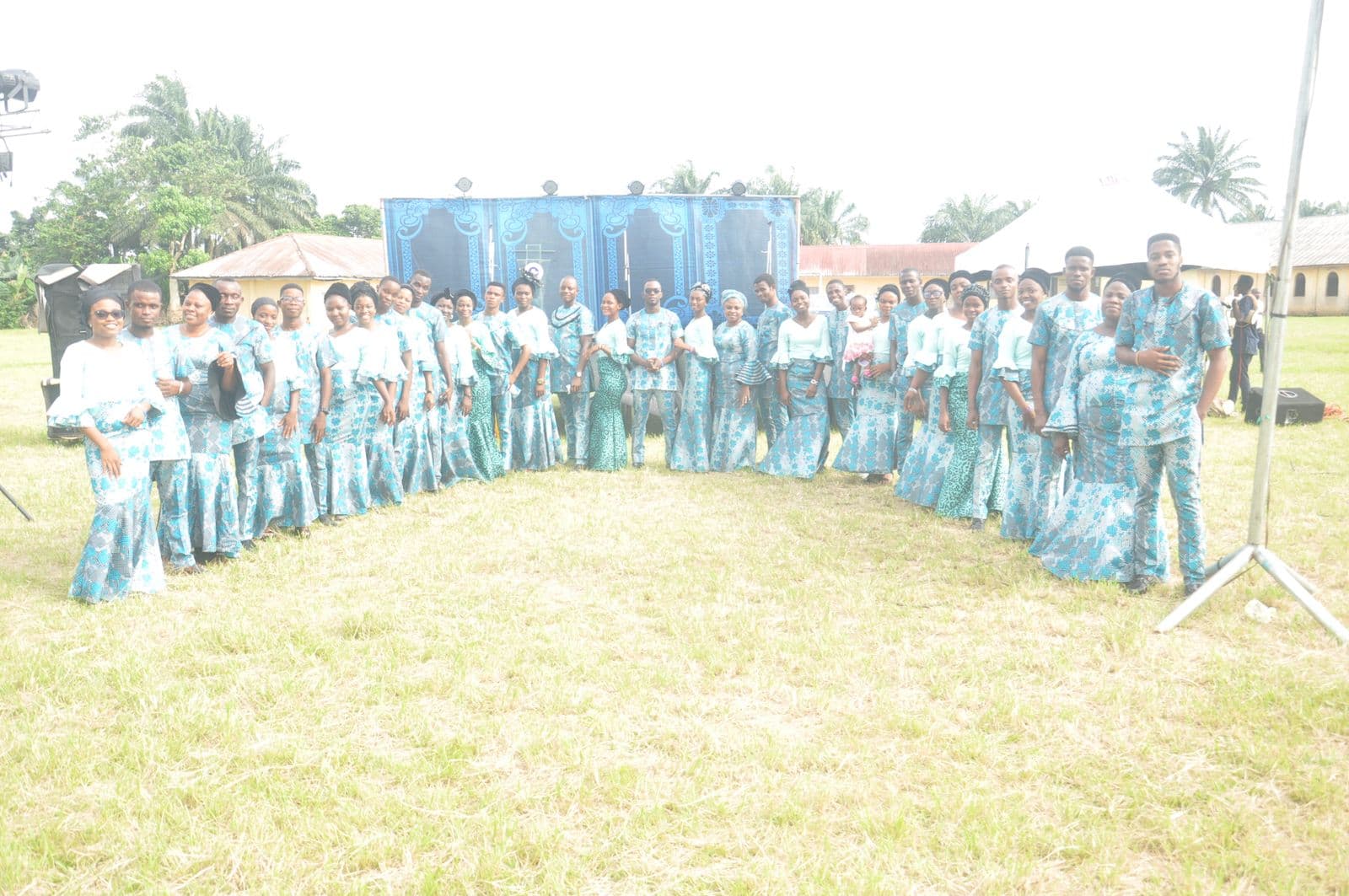 The whole company posed together outdoors before the event.
