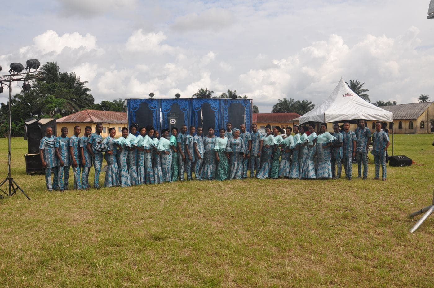 The company dancing together on the field.