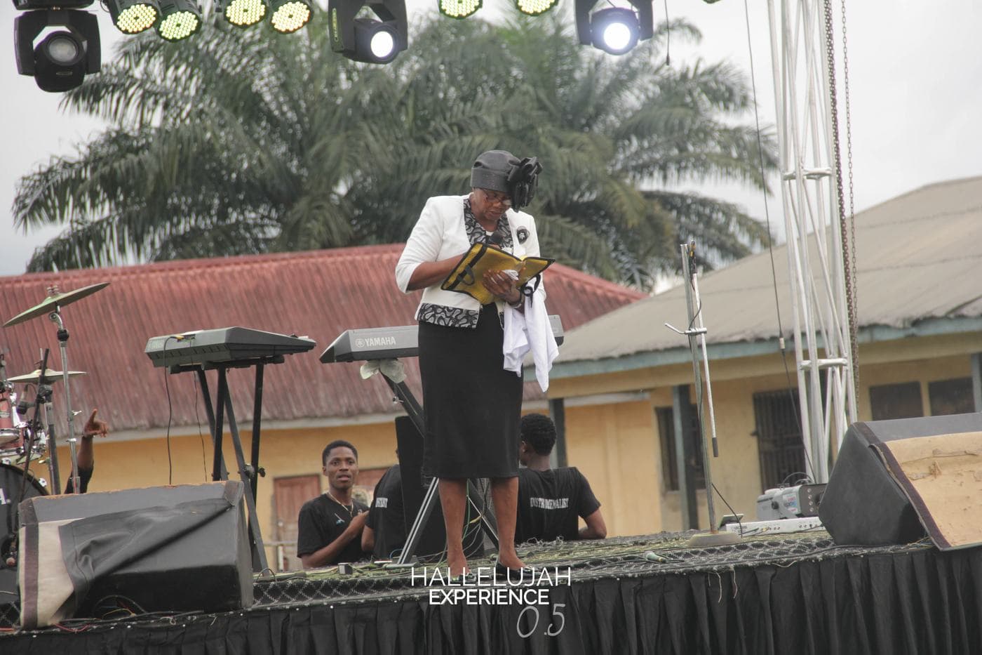 A member of the band performing on the outdoor stage.
