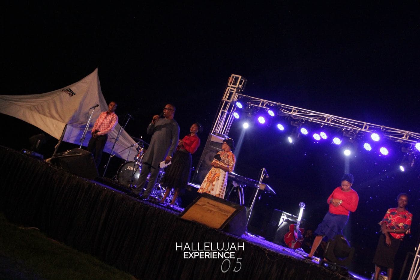 A member of the band performing on the outdoor stage.
