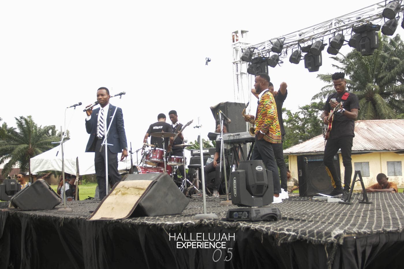 A member of the band performing on the outdoor stage.