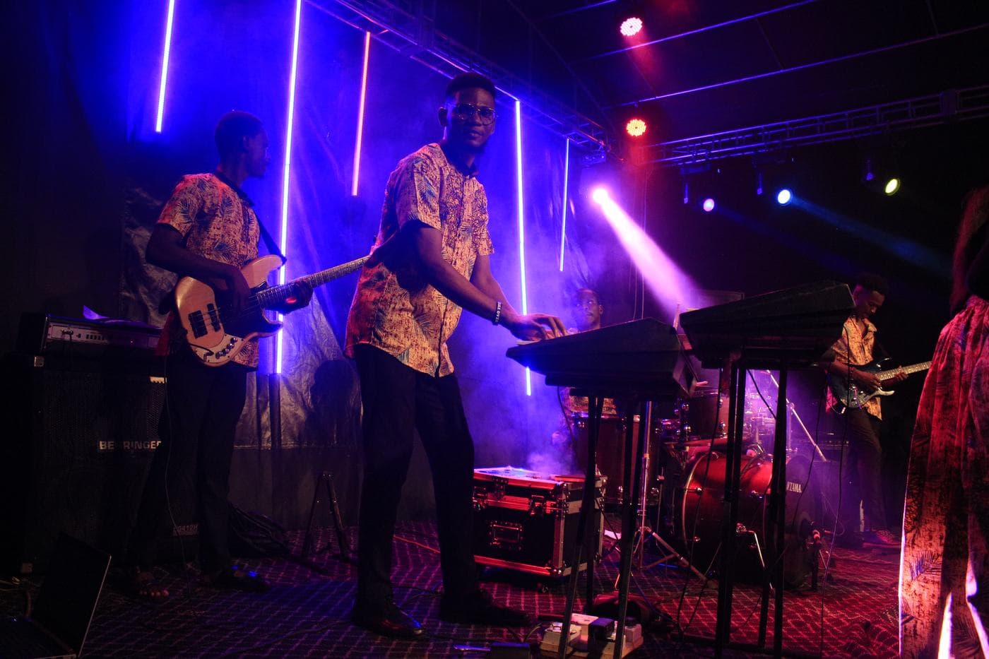 The choir singing together under coloured light.