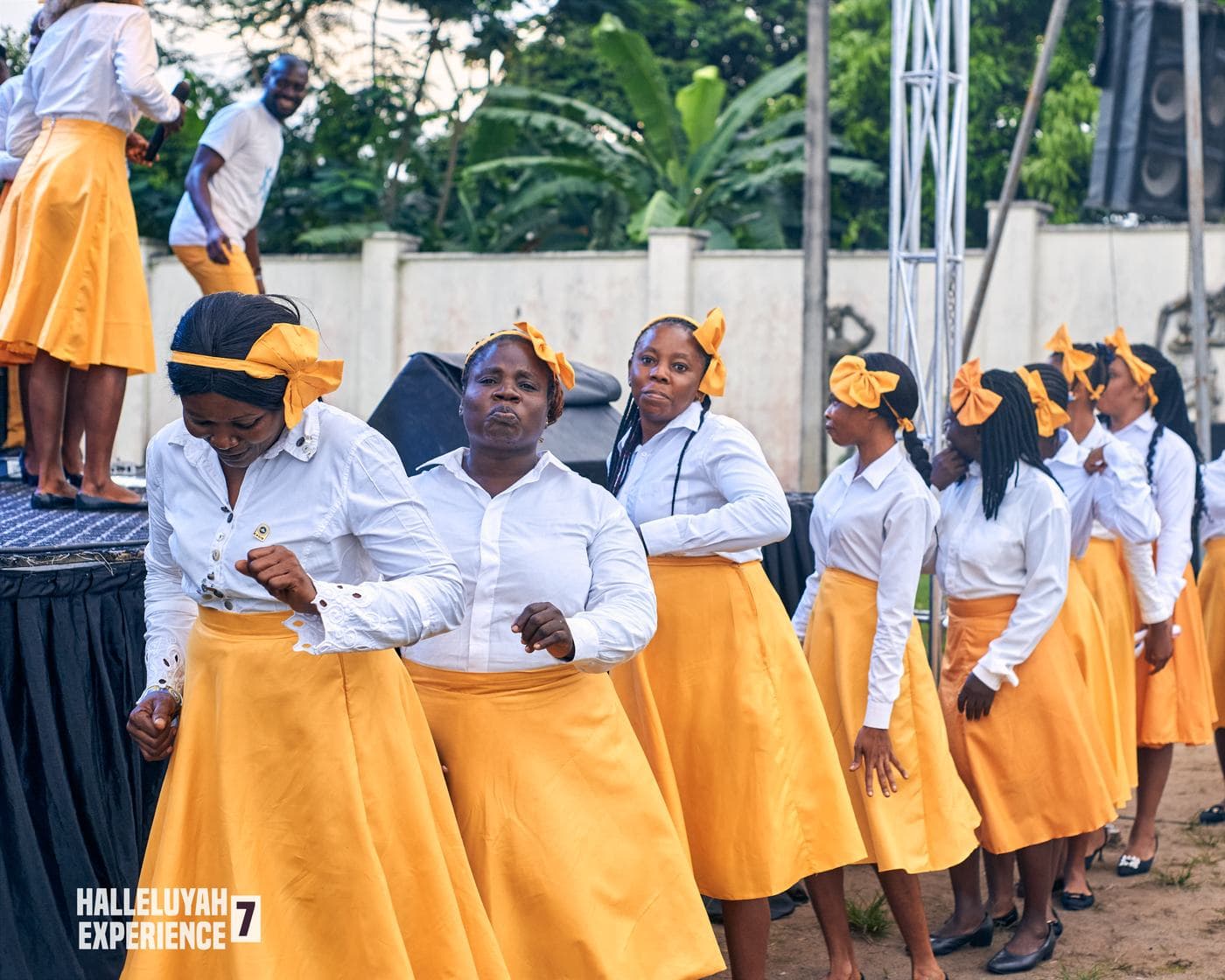 The choir performing in matching gold and white.