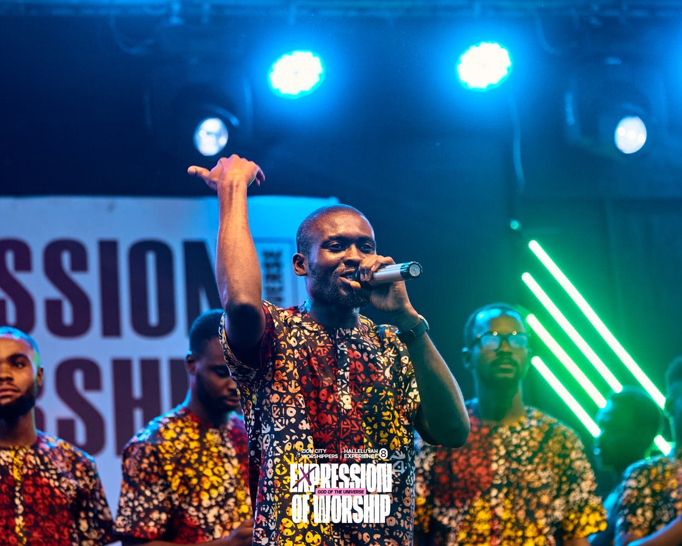 A soloist singing beneath the "Expression of Worship" backdrop.