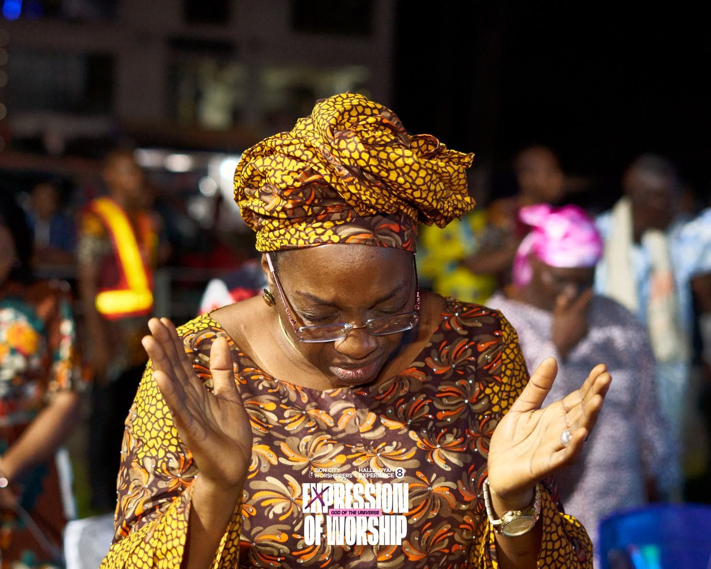 A worshipper with a hand raised.