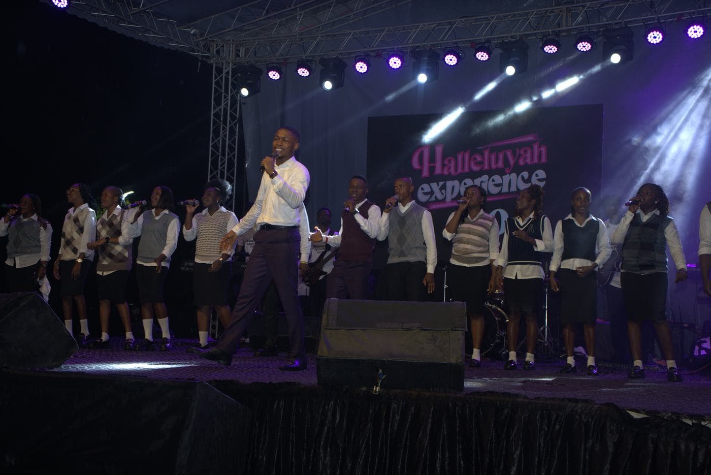 The choir performing beneath the "Halleluyah Experience" stage backdrop.